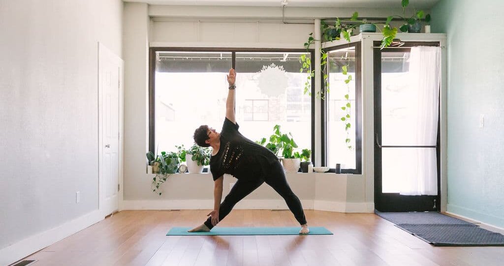 Rachel Holdgrafer, RYT 200, a plus-size yoga teacher, demonstrates extended triangle pose.