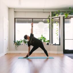 Rachel Holdgrafer, RYT 200, a plus-size yoga teacher, demonstrates extended triangle pose.