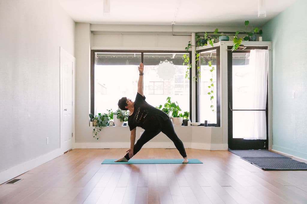 Rachel Holdgrafer, RYT 200, a plus-size yoga teacher, demonstrates extended triangle pose.