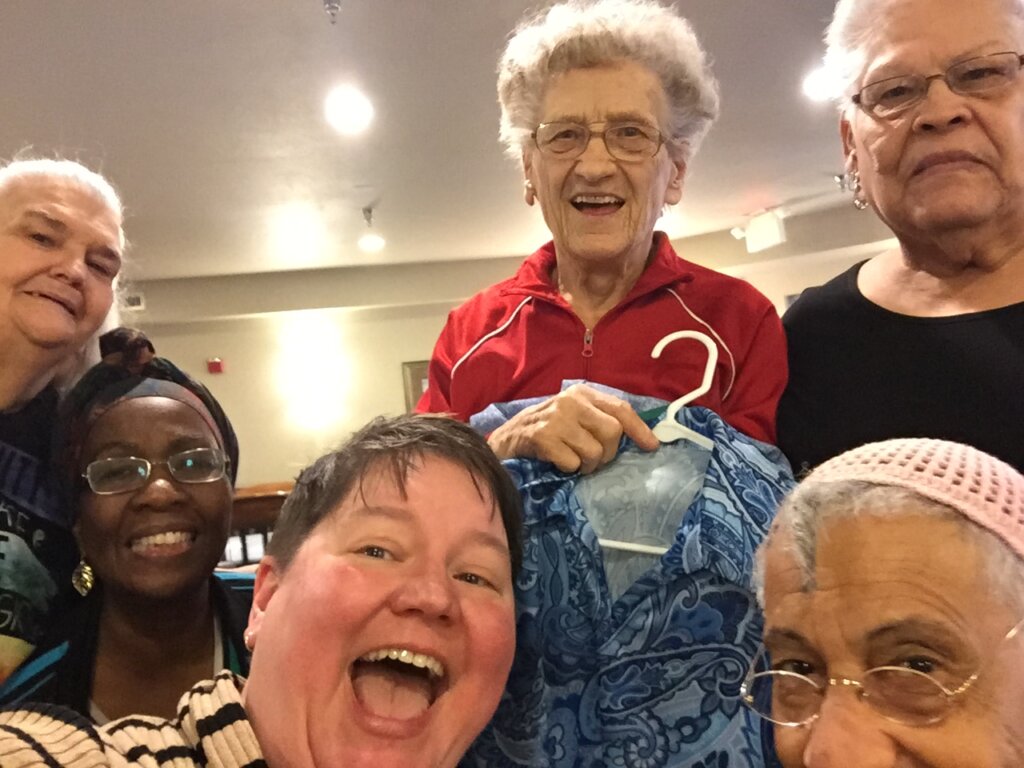 Five senior women pose with Nichole Vesperman after their chair yoga class.