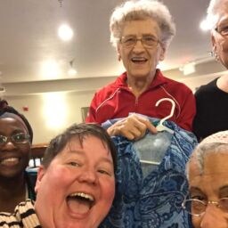 Five senior women pose with Nichole Vesperman after their chair yoga class.